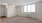 a room with a window and ceiling fan